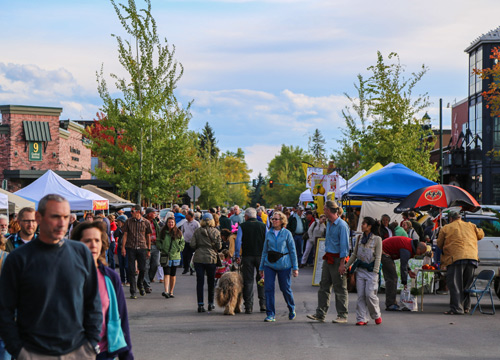 A group of shoppers browses the farmers market in Whitefish, Montana