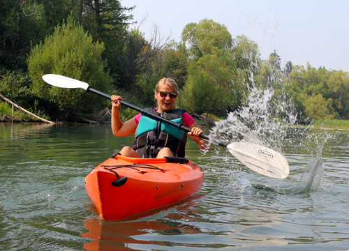 A kayaker having fun on the Whitefish River with Pine Lodge watercraft rentals