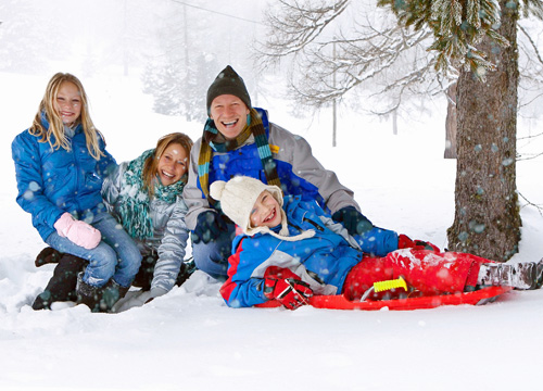 A family sledding in Whitefish, MT
