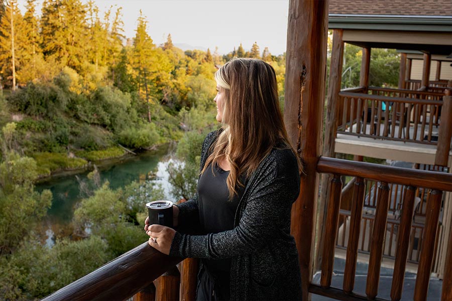 A guest at The Pine Lodge enjoying the view of Whitefish River